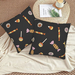 Halloween pillow covers with black candy pattern, styled on a woven chair