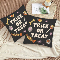 Halloween pillow covers with black candy pattern with a Trick or Treat message, styled on a woven chair