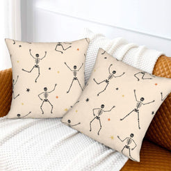 Halloween pillow covers with cream dancing skeletons, styled on a sofa