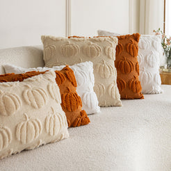 quilted polyester pillow covers with raised rust, cream and white pumpkin rows, lined across a cream sofa