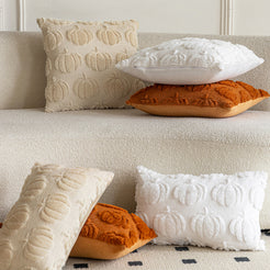 quilted polyester pillow covers with raised rust, cream and white pumpkin rows, arranged on and beside a cream sofa