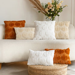 quilted polyester pillow covers with raised rust, cream and white pumpkin rows, displayed around a cream sofa