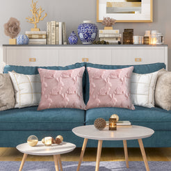 quilted polyester pillow covers with raised pink bunny silhouettes, styled on a teal sofa