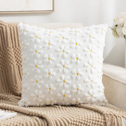 Quilted polyester pillow covers with raised white daisies, styled on a cream sofa