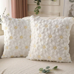 Quilted polyester pillow covers with raised cream pineapples, styled on a cream sofa