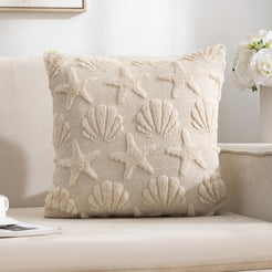 Quilted polyester pillow cover with raised seashells and starfish, styled on a cream sofa