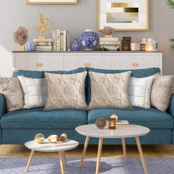 Quilted polyester pillow covers with raised seashells and starfish, styled on a teal sofa