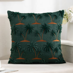 Quilted polyester pillow cover with raised palm trees on dark green, styled on a cream sofa