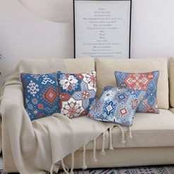 Bohemian short-pile plush pillow covers with blue and rose Aztec motifs, styled on a bed