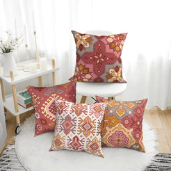 Bohemian short-pile plush pillow covers with terracotta and pink Aztec motifs, styled on a floor cushion