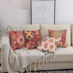 Bohemian short-pile plush pillow covers with terracotta and pink Aztec motifs, styled on a bed