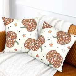 Set of two velvet pillow covers with cream plaid pumpkins and stars, styled on a sofa