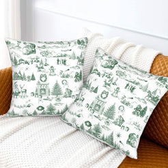 Green on white classic Christmas town toile velvet pillow covers styled on a bed