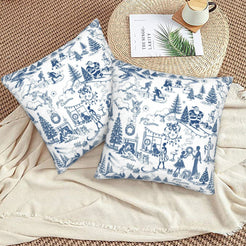 Blue on white winter holiday toile velvet pillow covers styled on a floor cushion