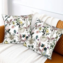 Tropical velvet pillow covers with white cranes and tropical flowers, styled on a sofa