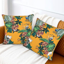 Tropical velvet pillow covers with mustard tropical birds and monstera leaves, styled on a sofa