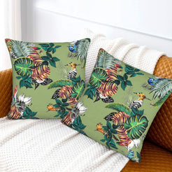 Tropical velvet pillow covers with sage tropical birds and monstera leaves, styled on a sofa