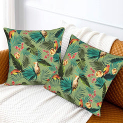 Tropical velvet pillow covers with sage palms and birds, styled on a sofa