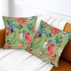 Tropical velvet pillow covers with sage parrots and flowers, styled on a sofa
