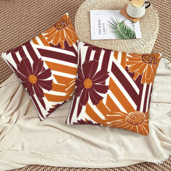 Fall velvet pillow covers with burgundy stripes and orange daisies, styled on a beige sofa