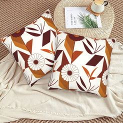 Fall velvet pillow covers with cream geometric leaves and burgundy flowers, styled on a beige sofa
