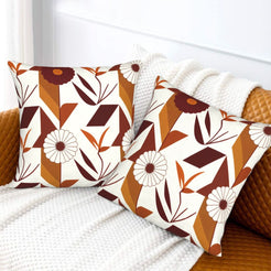Fall velvet pillow covers with cream geometric leaves and burgundy flowers, styled on a white sofa