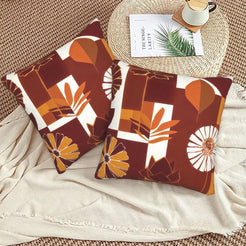 Fall velvet pillow covers with burgundy abstract blocks, leaves and flowers, styled on a beige sofa