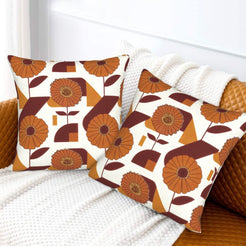 Fall velvet pillow covers with cream retro orange flowers and blocks, styled on a white sofa