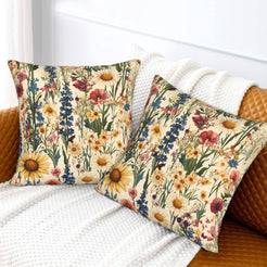 Velvet pillow covers with red poppies, sunflowers and blue wildflowers, styled on a cream sofa