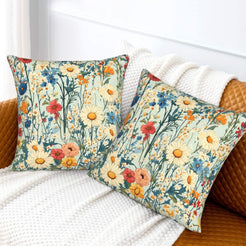 Velvet pillow covers with red poppies and blue meadow flowers on pale aqua, styled on a cream sofa