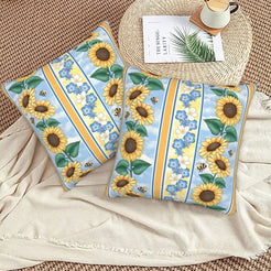 Velvet pillow covers with blue striped sunflowers, styled on a beige sofa