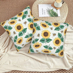 Velvet pillow covers with sunflowers, bees and green leaves on white, styled on a beige sofa