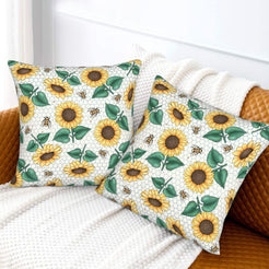 Velvet pillow covers with sunflowers, bees and green leaves on white, styled on a white sofa
