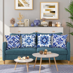 Short-pile plush pillow covers with blue and white floral tile medallions, styled on a teal sofa