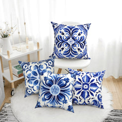 Short-pile plush pillow covers with blue and white floral tile medallions, styled in a bright room