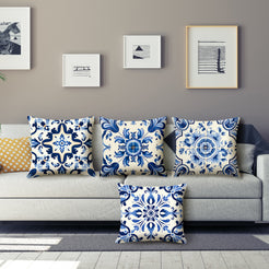 Short-pile plush pillow covers with blue and white ornate tile medallions, styled on a gray sofa