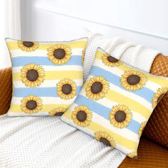 Velvet pillow covers with sunflowers on pale blue and yellow stripes, styled on a white sofa