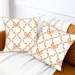Fall velvet pillow covers with a brown bow lattice pattern, styled on a white sofa