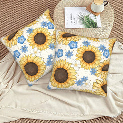 Velvet pillow covers with sunflowers and small blue flowers on white, styled on a beige sofa