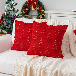Quilted polyester pillow covers with gold embroidered trees on red, styled on a cream sofa