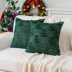 Quilted polyester pillow covers with gold embroidered trees on dark green, styled on a cream sofa