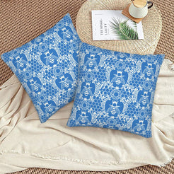 Velvet pillow covers with blue bees and floral lace pattern, styled on a beige sofa