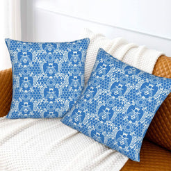 Velvet pillow covers with blue bees and floral lace pattern, styled on a white sofa