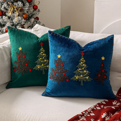 Green and blue embroidered Christmas tree velvet pillow covers on a sofa