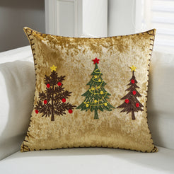 Gold velvet pillow cover with embroidered Christmas trees on a sofa