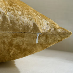 Back view of a gold velvet pillow cover with hidden zipper