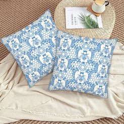 Velvet pillow covers with blue and white bees with floral lace pattern, styled on a beige sofa