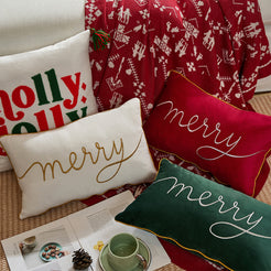 Red, green and ivory embroidered Merry pillow covers in a Christmas setting