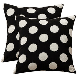 Set of two loop-pile textured polyester pillow covers with raised white polka dots on black