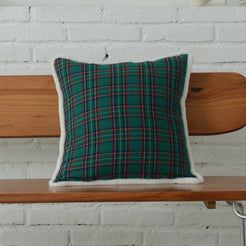 Green tartan woven cotton-polyester blend square pillow cover styled on a bed